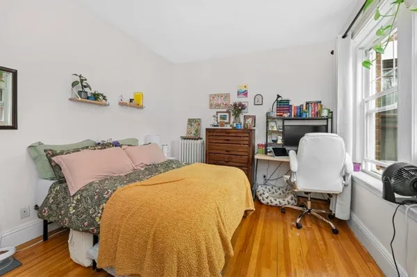 a bed room with a bed and a chair