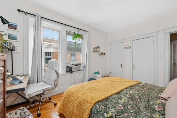 a bedroom with a bed and a table in it