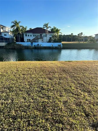 an aerial view of residential houses with outdoor space and lake view