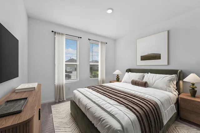 a bedroom with a bed and a television