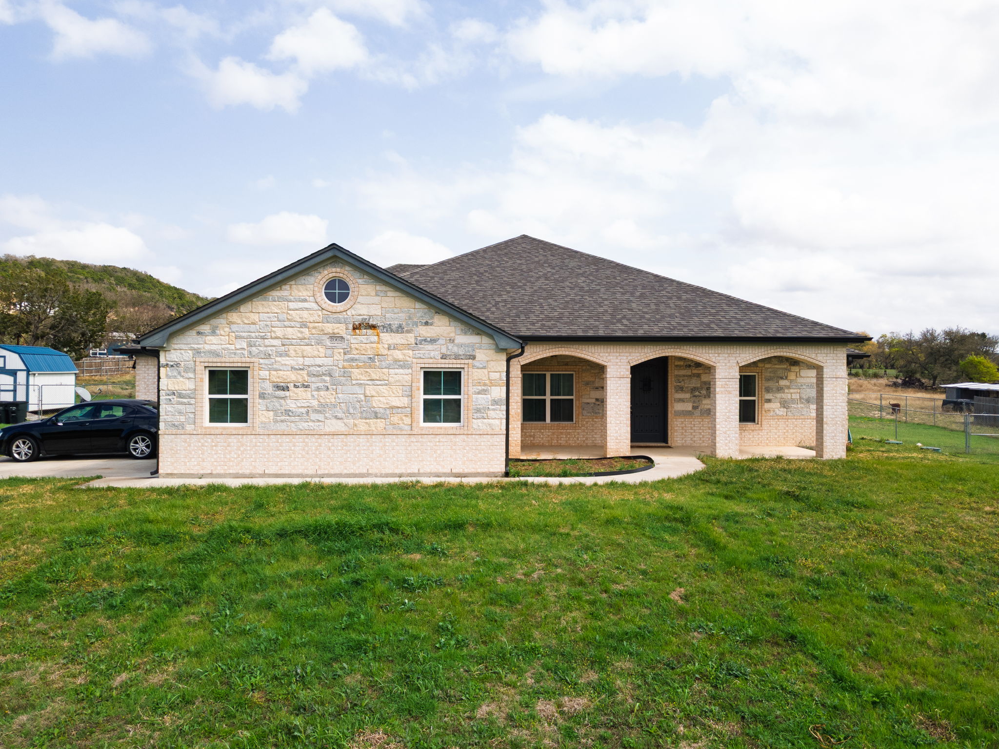 a front view of house with yard and green space