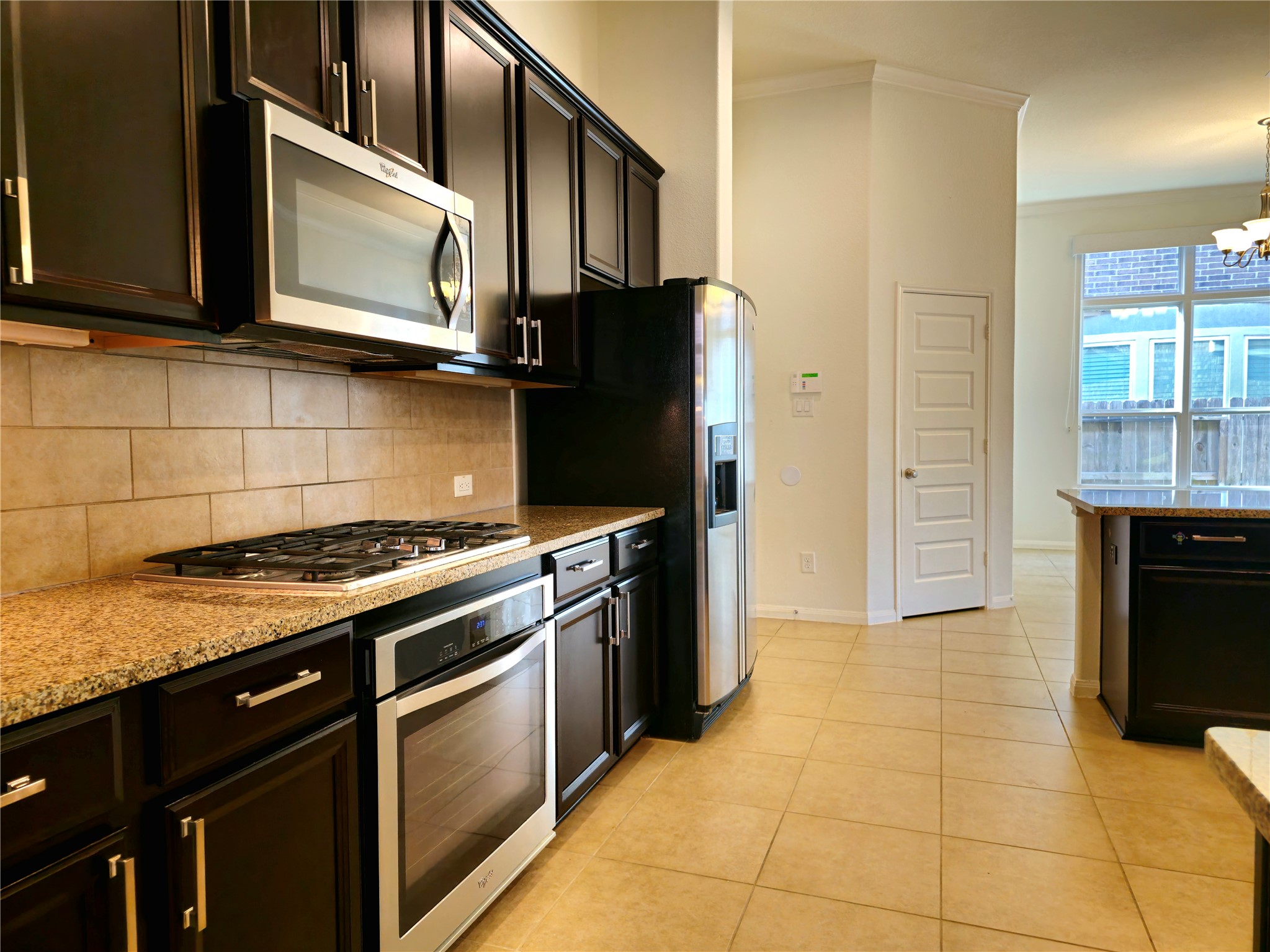 22106 Flashing Ridge Spring, TX 77389 - Photo 11 of 44 a kitchen with granite countertop a stove and a microwave