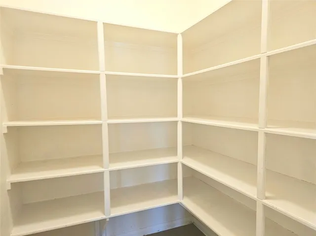 a view of a walk in closet with empty racks
