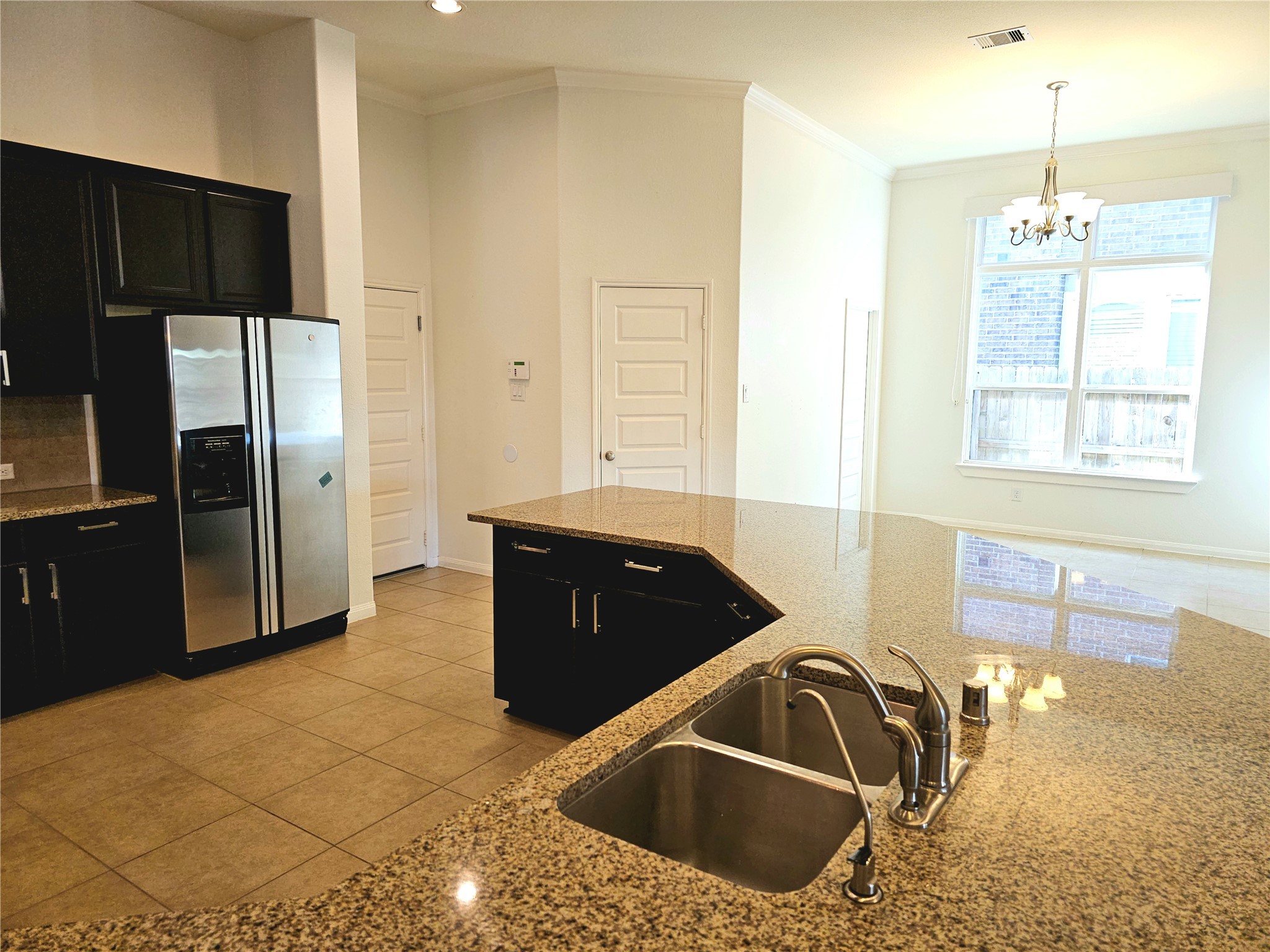 22106 Flashing Ridge Spring, TX 77389 - Photo 16 of 44 a kitchen with a sink and a refrigerator