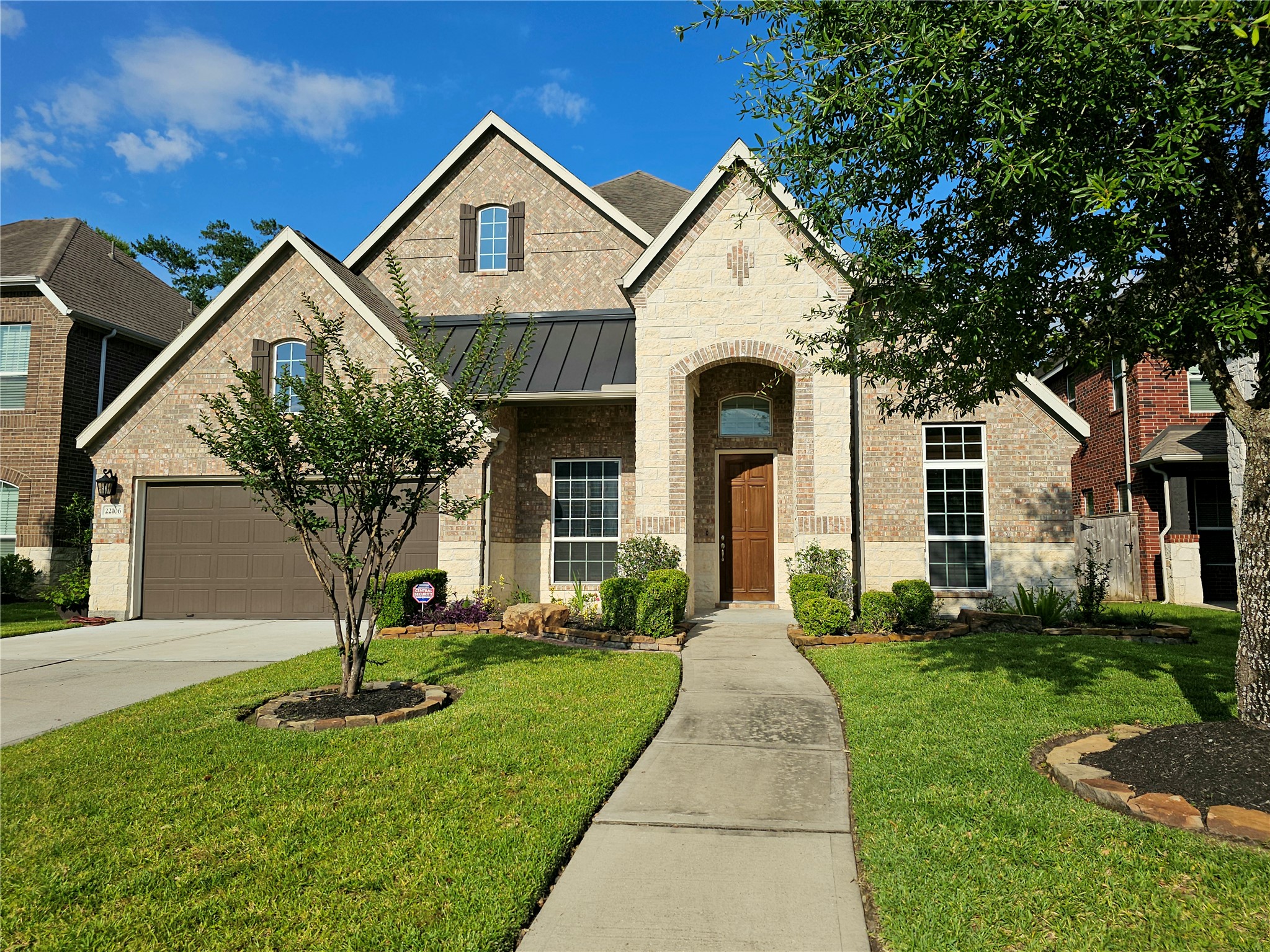 22106 Flashing Ridge Spring, TX 77389 - Photo 2 of 44 a front view of a house with a yard and garage