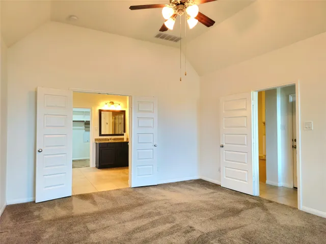 wooden floor in an empty room with a bathroom