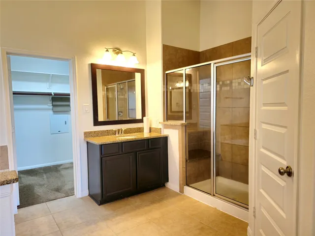 a bathroom with a shower and a sink