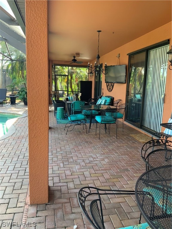 12918 Pastures Way Fort Myers, FL 33913 - Photo 12 of 34 a view of a patio with table and chairs with wooden floor and fence