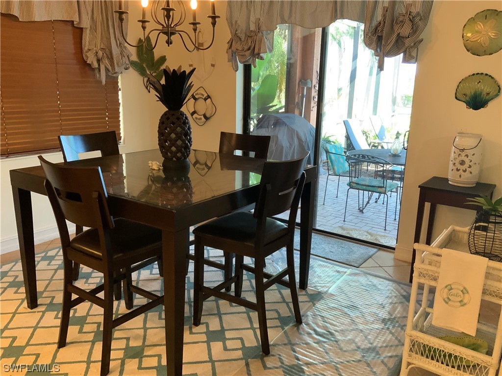 12918 Pastures Way Fort Myers, FL 33913 - Photo 14 of 34 a view of a dining room with furniture and wooden floor