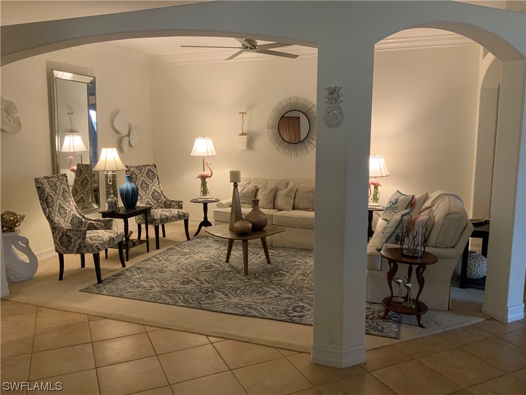 12918 Pastures Way Fort Myers, FL 33913 - Photo 16 of 34 a living room with couches and a dining table with wooden floor