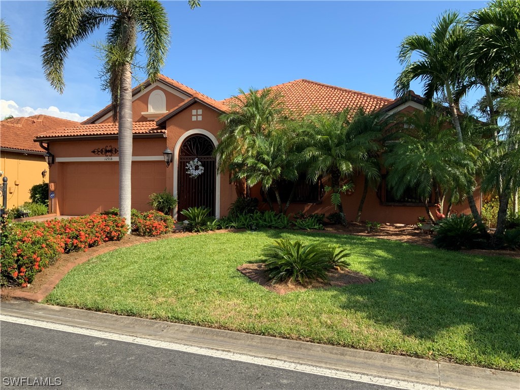 12918 Pastures Way Fort Myers, FL 33913 - Photo 2 of 34 a front view of a house with a yard