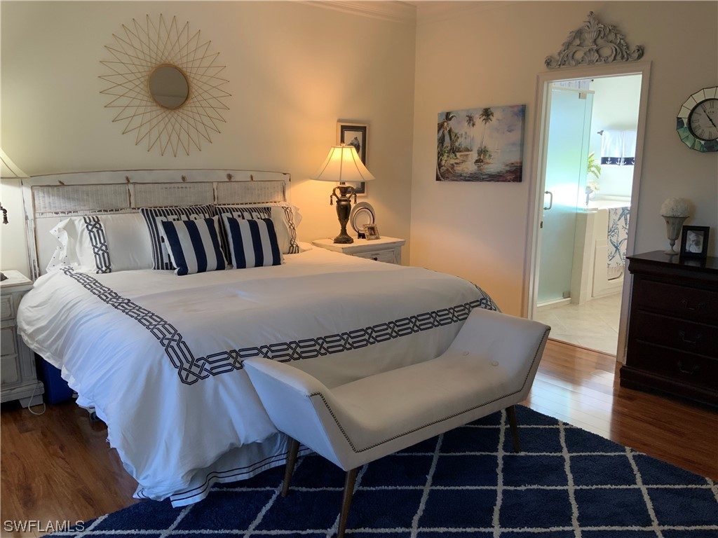 12918 Pastures Way Fort Myers, FL 33913 - Photo 21 of 34 a bedroom with a bed and a table in it