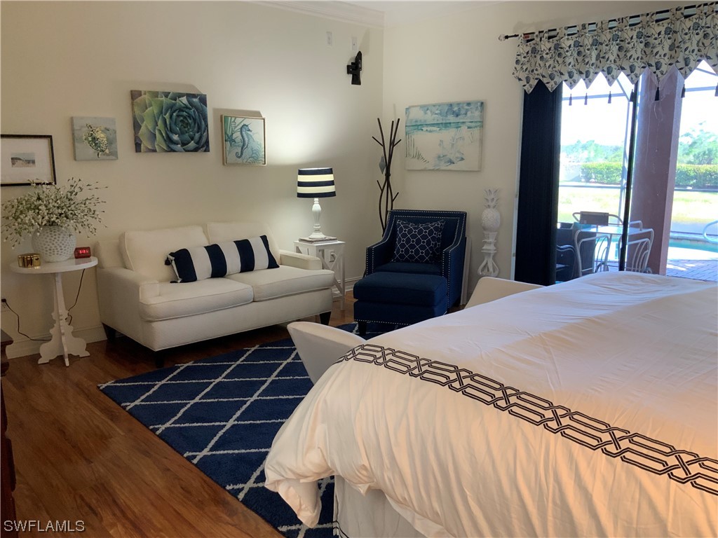 12918 Pastures Way Fort Myers, FL 33913 - Photo 23 of 34 a spacious bedroom with a bed mirror and window