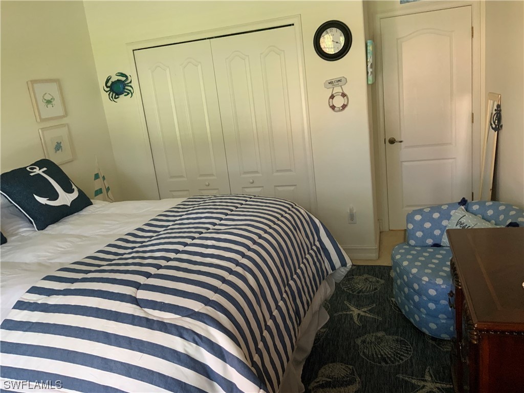 12918 Pastures Way Fort Myers, FL 33913 - Photo 27 of 34 a bedroom with a bed and a shower
