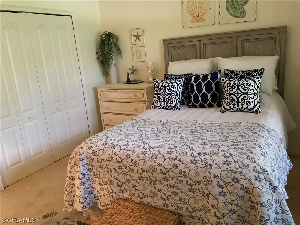 12918 Pastures Way Fort Myers, FL 33913 - Photo 29 of 34 a bed sitting in a bedroom next to a cabinet