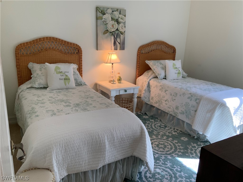12918 Pastures Way Fort Myers, FL 33913 - Photo 33 of 34 a bedroom with double bed and a painting on the wall
