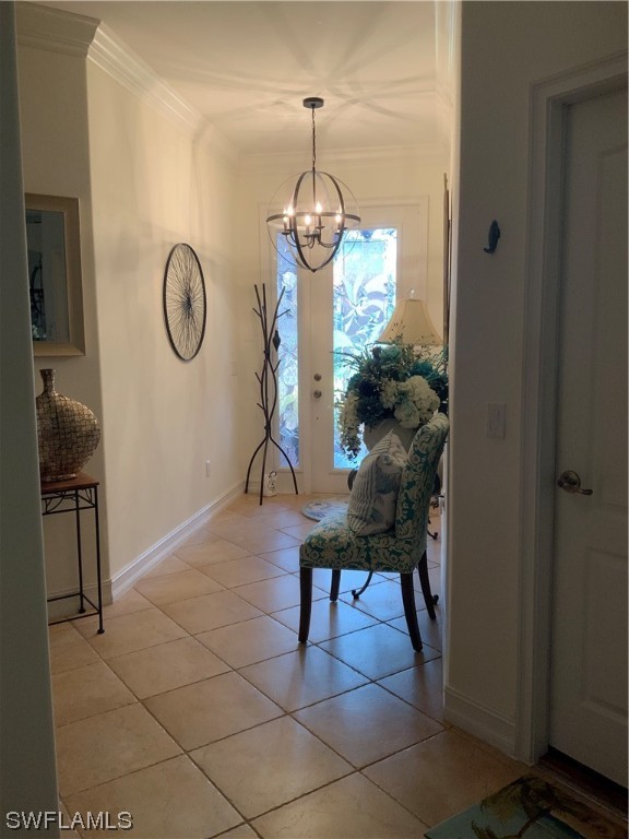 12918 Pastures Way Fort Myers, FL 33913 - Photo 5 of 34 a view of a hallway with entryway wooden floor and a chandelier