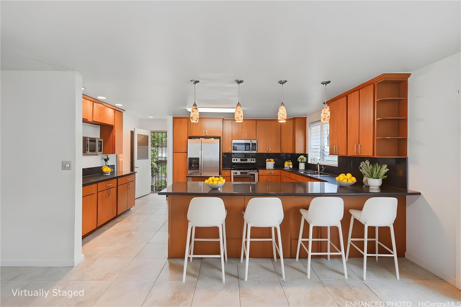47-325 Ahuimanu Road Kaneohe, HI 96744 - Photo 13 of 24 a large kitchen with a table and chairs