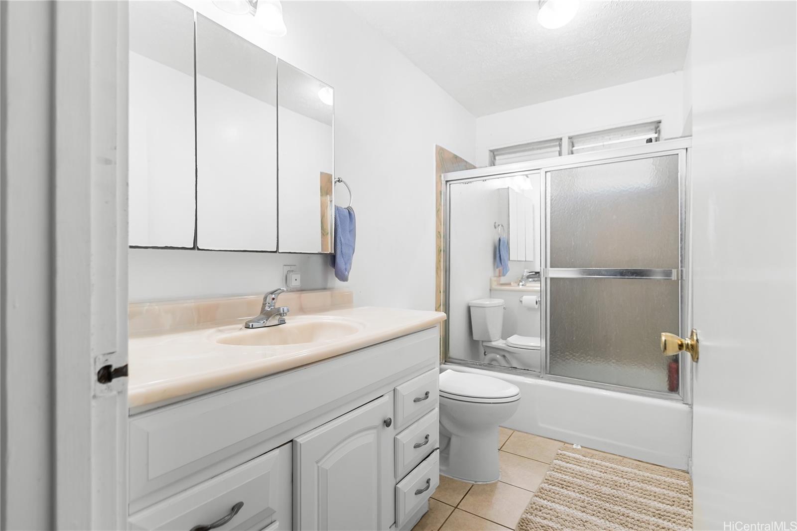 47-325 Ahuimanu Road Kaneohe, HI 96744 - Photo 15 of 24 a bathroom with a sink a toilet and shower