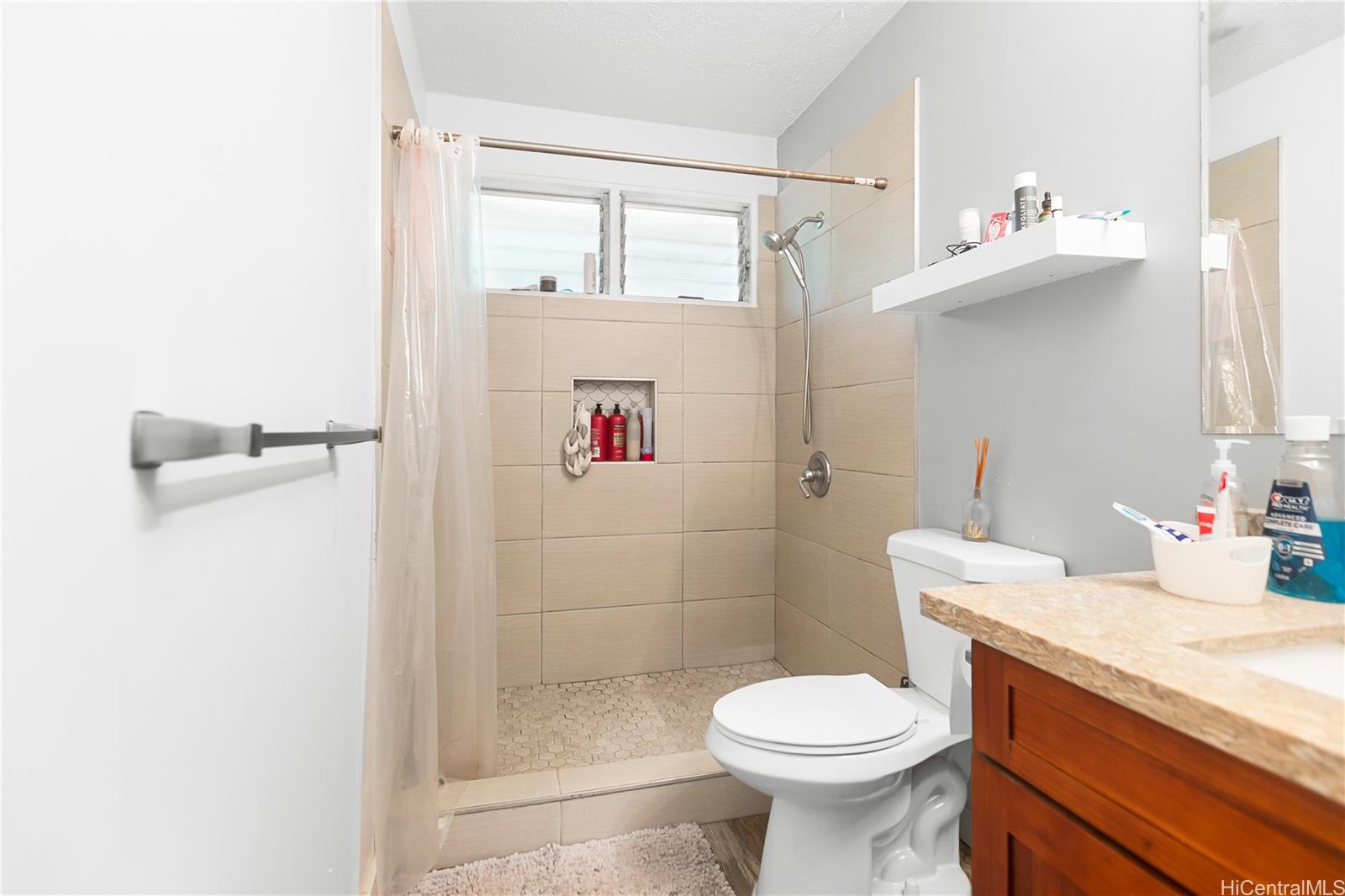 47-325 Ahuimanu Road Kaneohe, HI 96744 - Photo 17 of 24 a bathroom with a sink toilet and shower