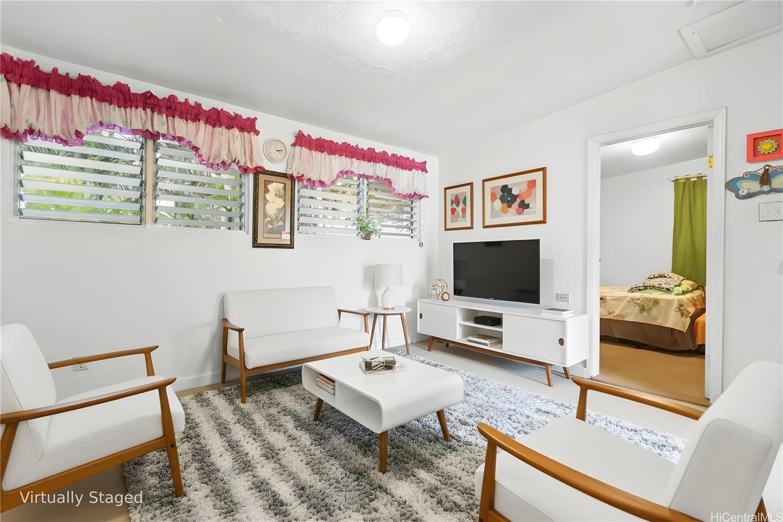 47-325 Ahuimanu Road Kaneohe, HI 96744 - Photo 19 of 24 a living room with furniture and a flat screen tv