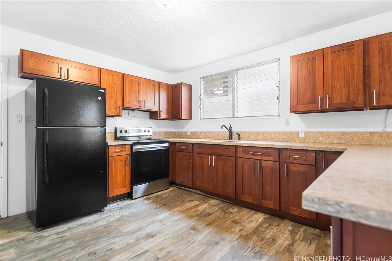 47-325 Ahuimanu Road Kaneohe, HI 96744 - Photo 6 of 24 a kitchen with stainless steel appliances granite countertop a refrigerator and a sink