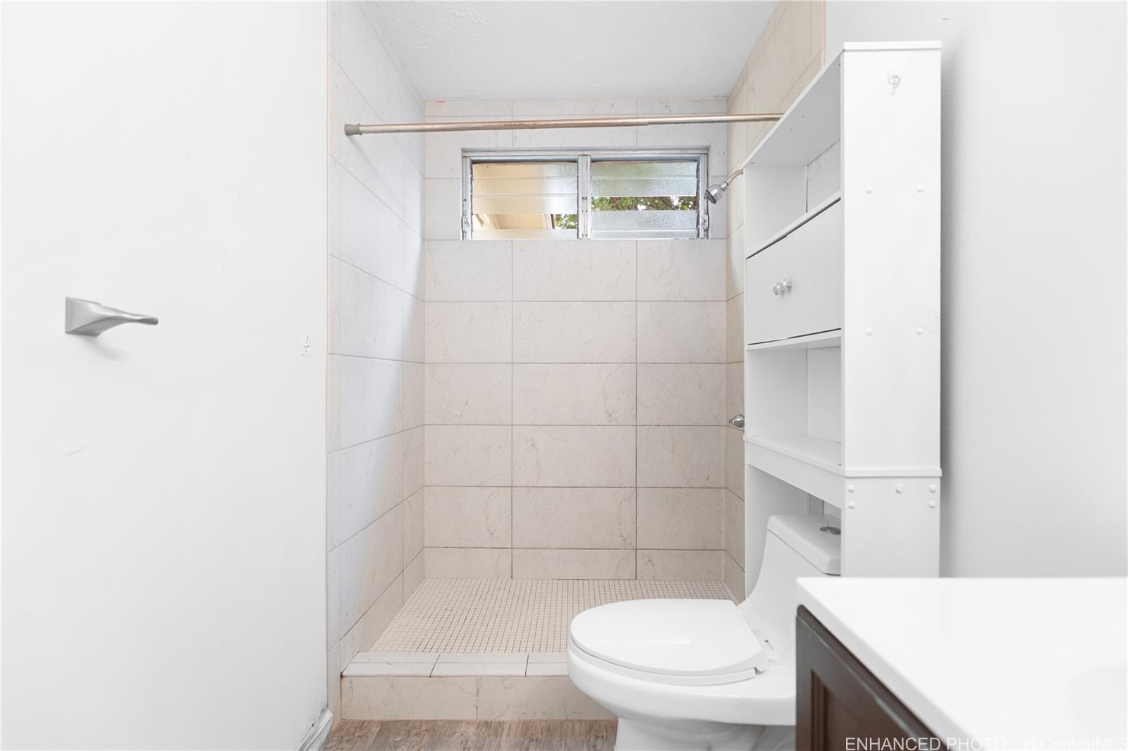 47-325 Ahuimanu Road Kaneohe, HI 96744 - Photo 10 of 24 a white toilet sitting next to a bathroom sink