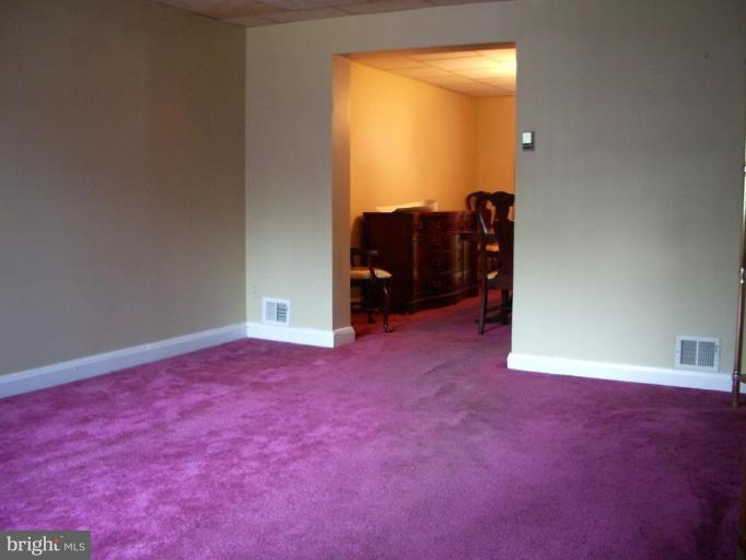1119 Wicklow Road Baltimore, MD 21229 - Photo 4 of 11 an empty room with windows