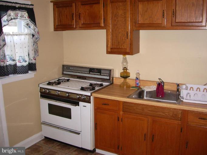 1119 Wicklow Road Baltimore, MD 21229 - Photo 7 of 11 a kitchen with a stove and a cabinets