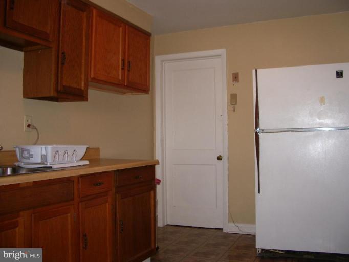 1119 Wicklow Road Baltimore, MD 21229 - Photo 8 of 11 a kitchen with stainless steel appliances granite countertop a refrigerator and a sink