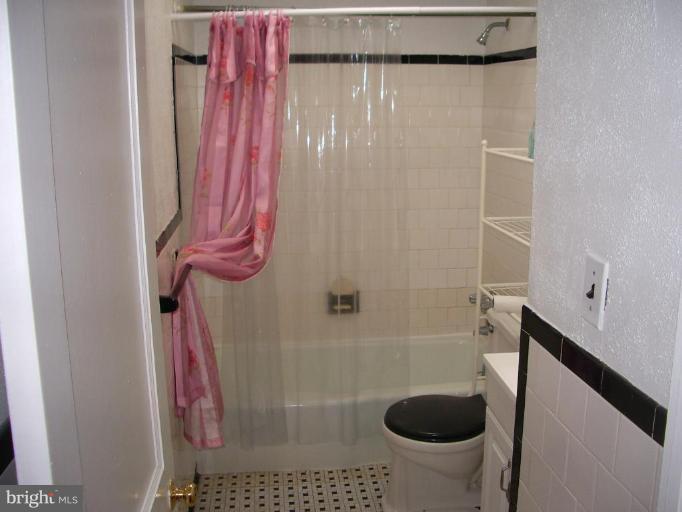 1119 Wicklow Road Baltimore, MD 21229 - Photo 10 of 11 a bathroom with a shower a toilet and a sink