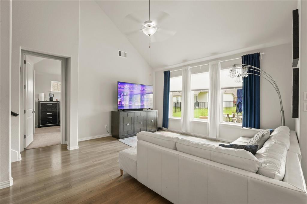 3217 Flowering Peach Dr. Heath, TX 75126 - Photo 11 of 30 a living room with furniture and a flat screen tv