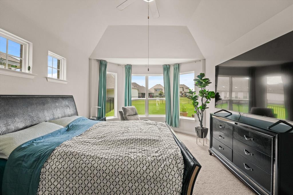 3217 Flowering Peach Dr. Heath, TX 75126 - Photo 13 of 30 a bedroom with a bed and a large window