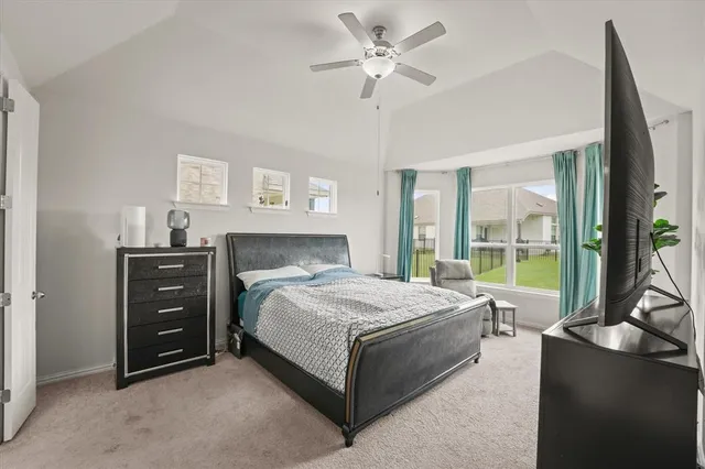 a bedroom with a bed and a large window