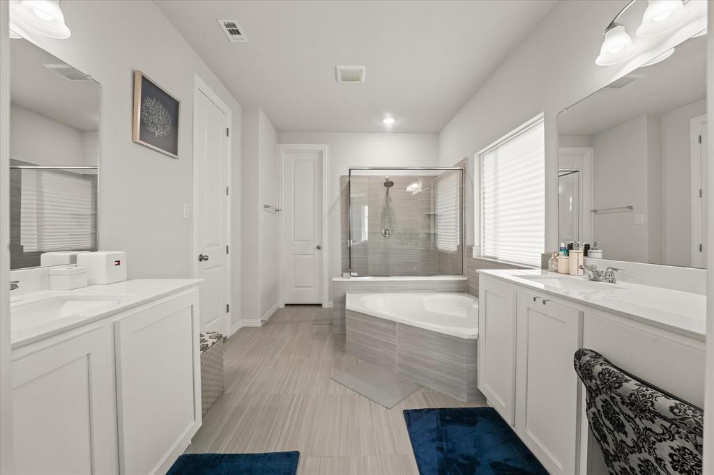 3217 Flowering Peach Dr. Heath, TX 75126 - Photo 15 of 30 a bathroom with a tub sink and mirror