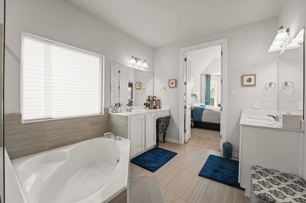 3217 Flowering Peach Dr. Heath, TX 75126 - Photo 16 of 30 a bathroom with a tub sink and mirror