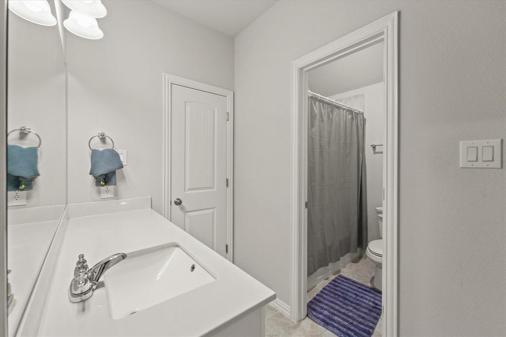 3217 Flowering Peach Dr. Heath, TX 75126 - Photo 18 of 30 a bathroom with a sink and mirror