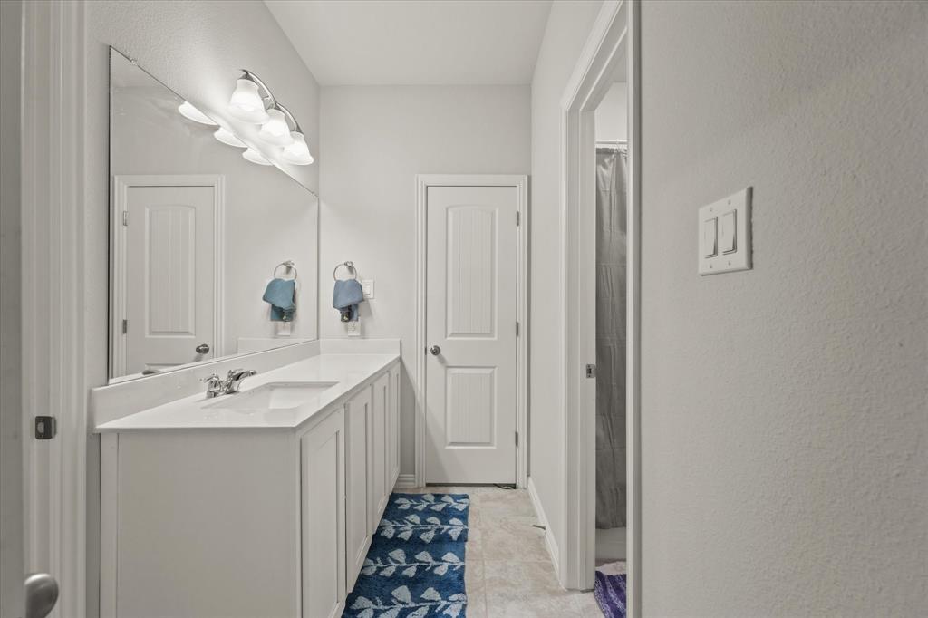 3217 Flowering Peach Dr. Heath, TX 75126 - Photo 19 of 30 a bathroom with 2 sink and a mirror