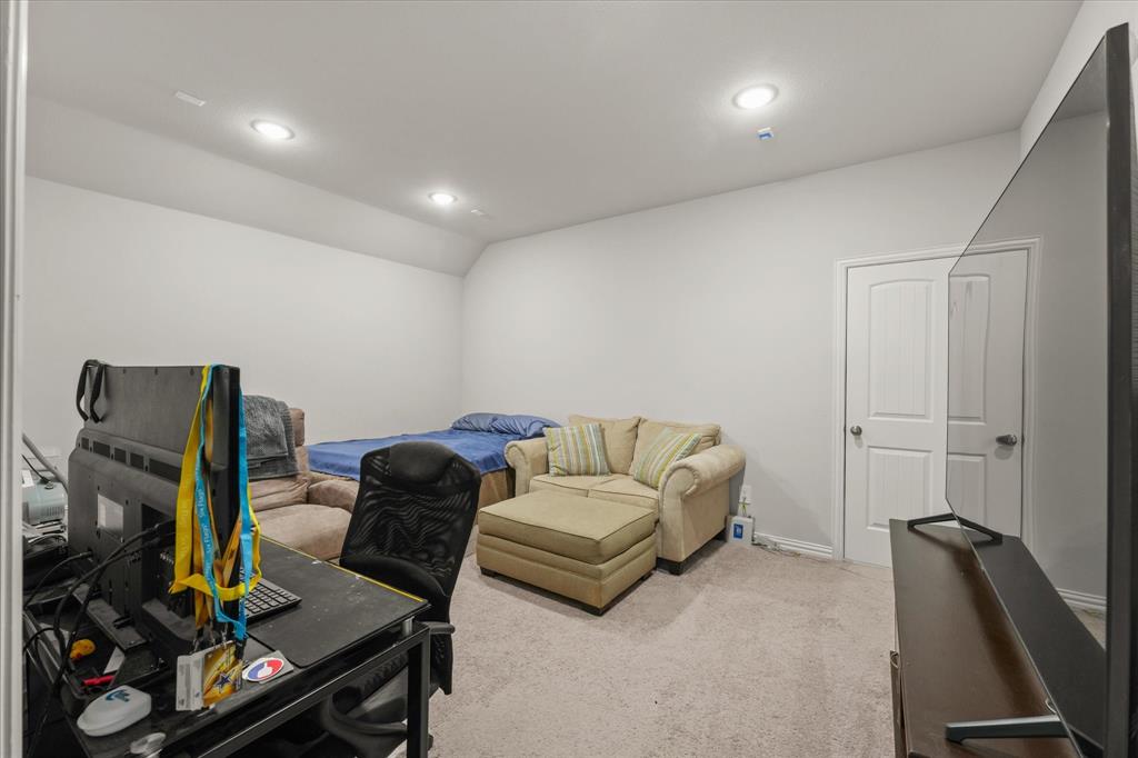 3217 Flowering Peach Dr. Heath, TX 75126 - Photo 22 of 30 a living room with furniture and a flat screen tv