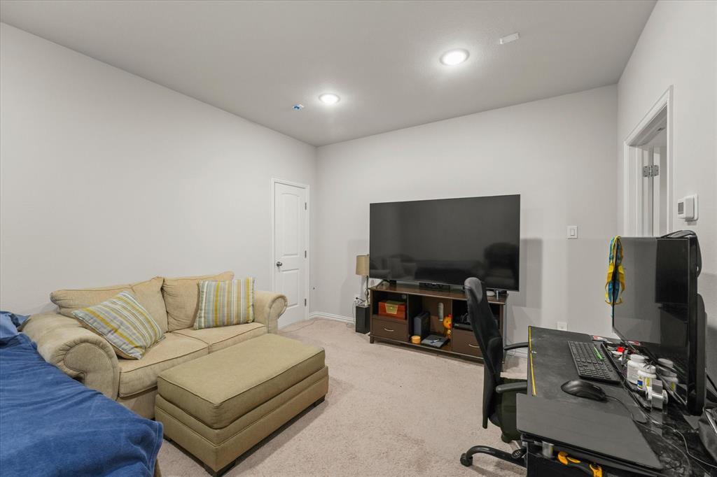 3217 Flowering Peach Dr. Heath, TX 75126 - Photo 23 of 30 a living room with furniture and a flat screen tv