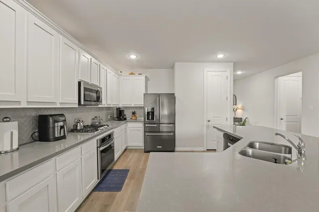 a kitchen with refrigerator a sink and cabinets