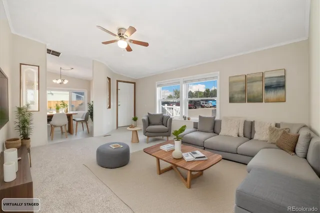 a living room with furniture a fireplace and a chandelier