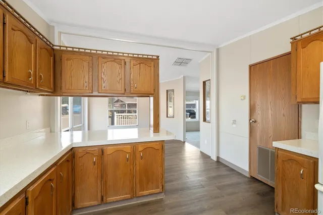 a view of kitchen with wooden floor and electronic appliances