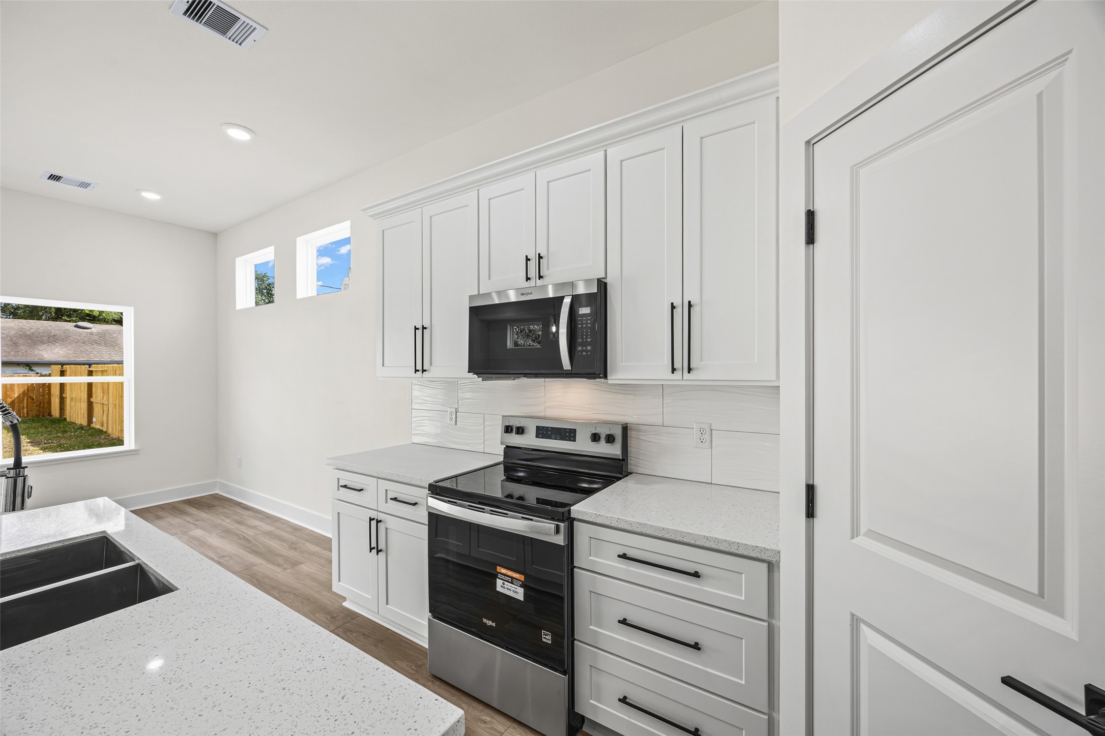 443 Hahlo Street Houston, TX 77020 - Photo 14 of 27 a kitchen with stainless steel appliances a stove a microwave and a refrigerator