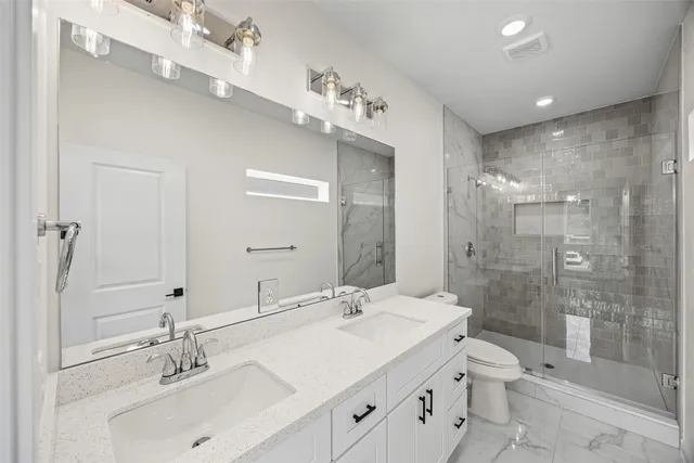 a bathroom with a sink shower and a mirror