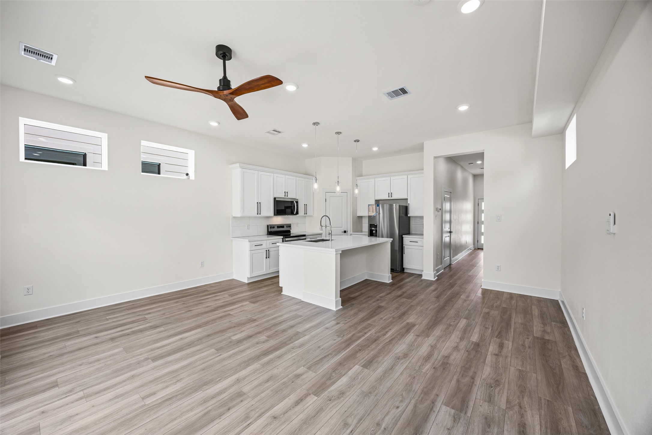 443 Hahlo Street Houston, TX 77020 - Photo 10 of 27 a view of kitchen with wooden floor and window