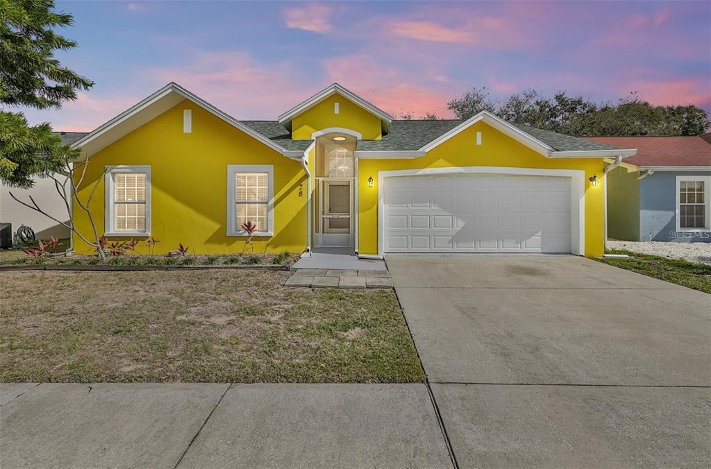 a front view of house with yard and swimming pool