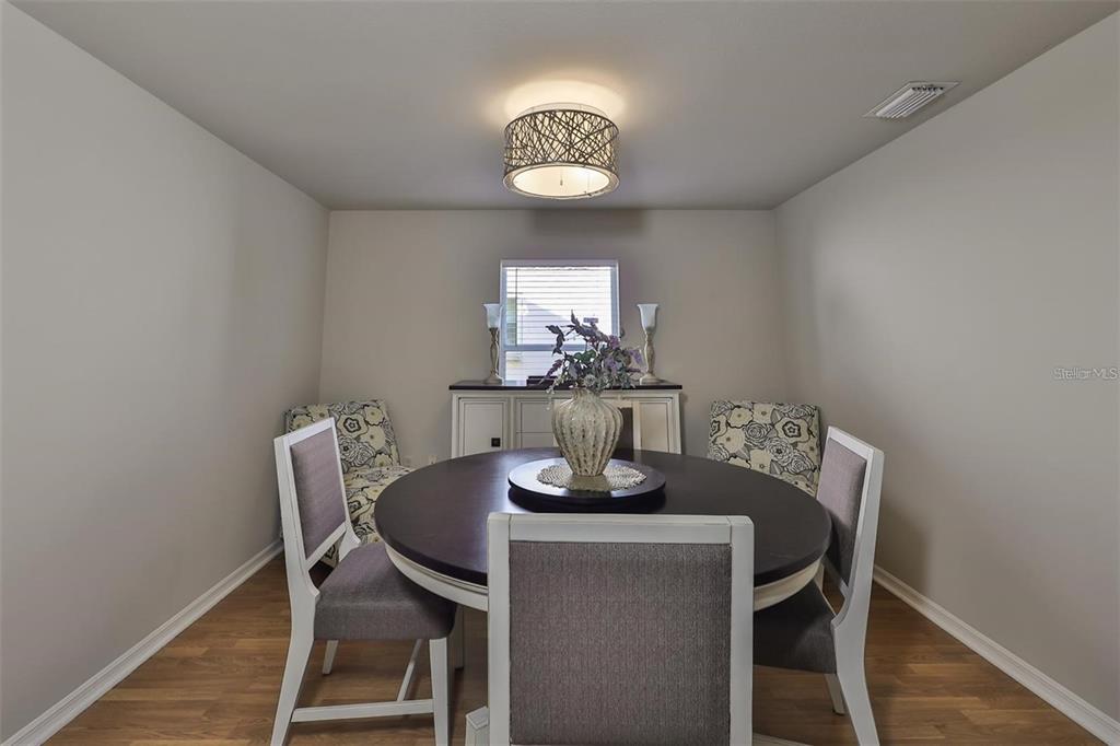 128 Lookout Drive Apollo Beach, FL 33572 - Photo 11 of 36 a dining room with furniture and chandelier