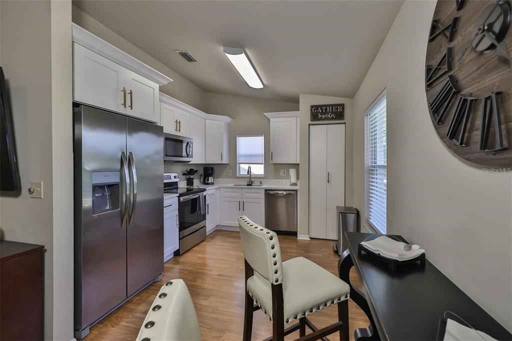 128 Lookout Drive Apollo Beach, FL 33572 - Photo 14 of 36 a kitchen with stainless steel appliances kitchen island granite countertop a refrigerator a sink a stove and oven