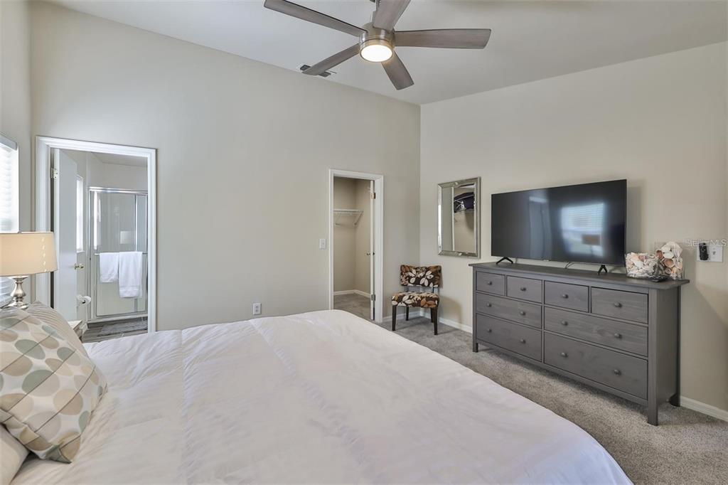 128 Lookout Drive Apollo Beach, FL 33572 - Photo 19 of 36 a bedroom with a bed and a flat screen tv